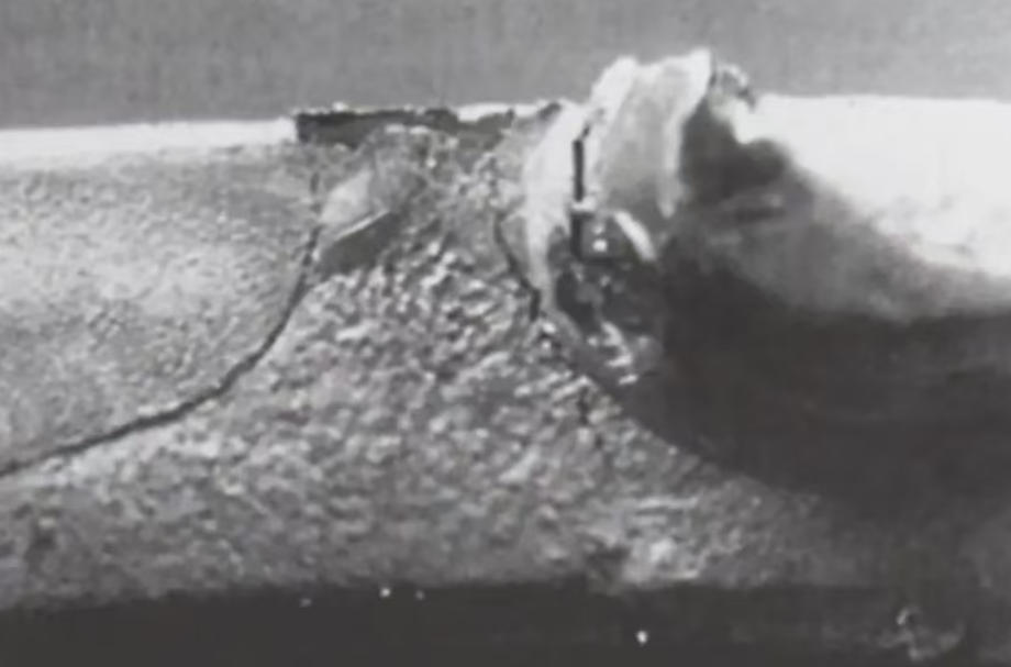 Hot tear defect near boss section of an aluminum die casting, indicated by crack propagation around the hole