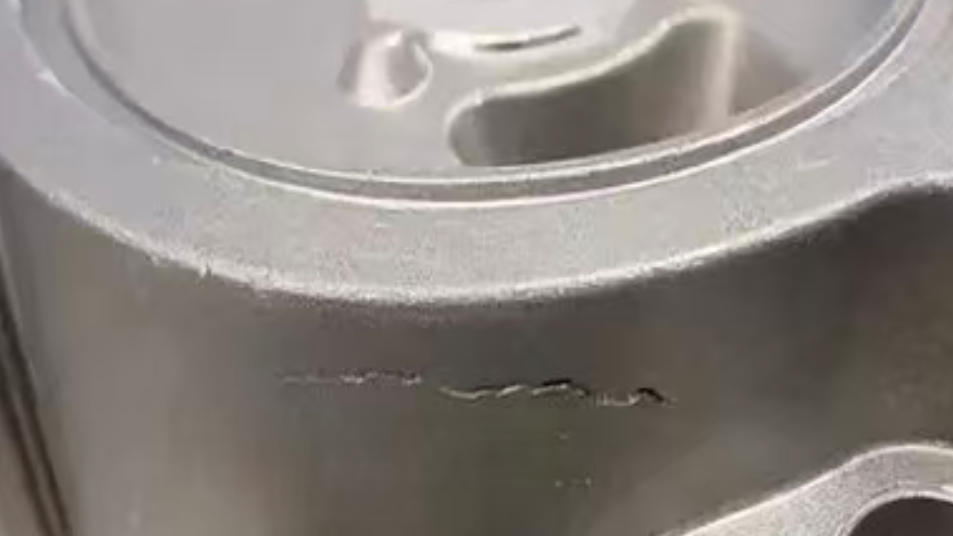 Microscopic view of hot tearing in aluminum die casting showing intergranular cracks along grain boundaries.